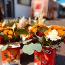 Gelb-weiße Blumengestecke in einer roten Eis-Verpackung beim OEDIV HR Services GmbH Sommerfest